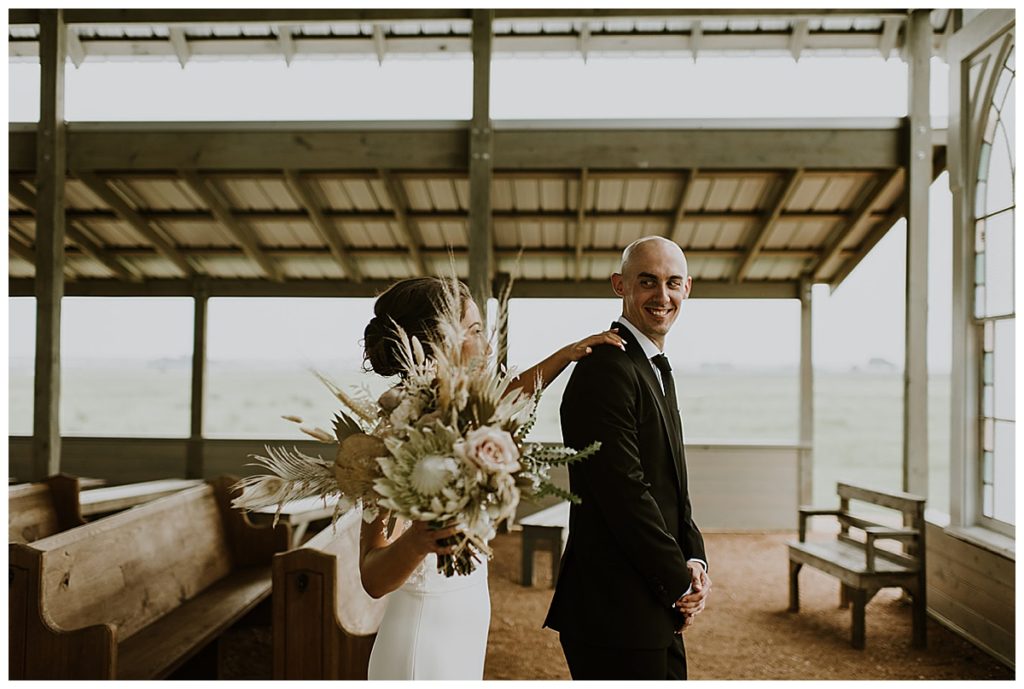 bride and groom first look in allen farmhaus chapel