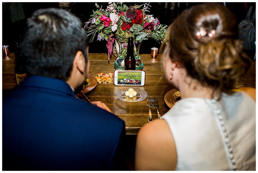 bride and groom watching Baylor football at their sweetheart table