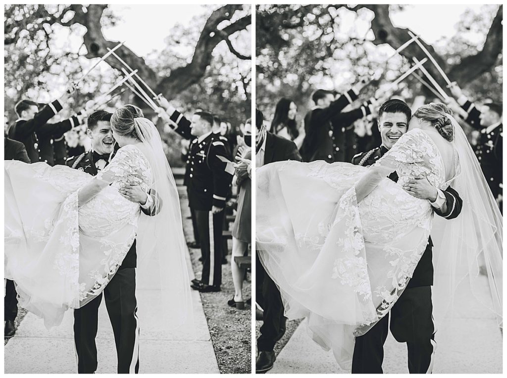 groom carries bride after ceremony at park31