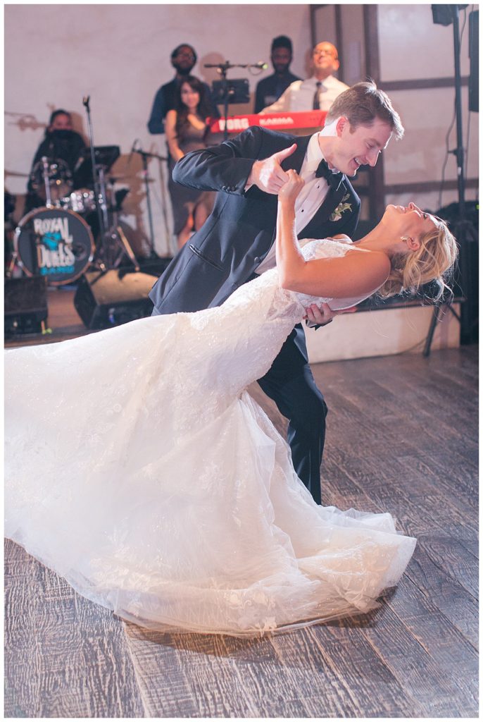 groom dips bride during first dance at lost mission