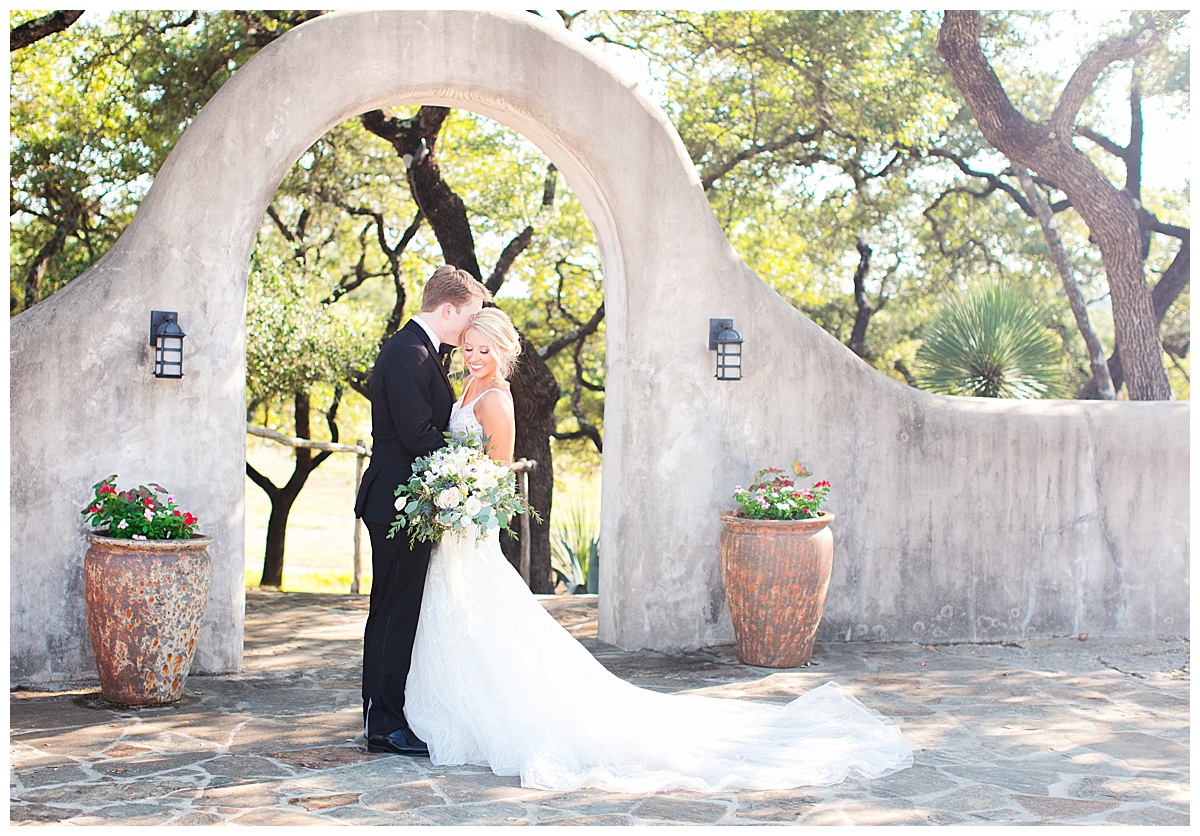 bride and groom in front of lost mission