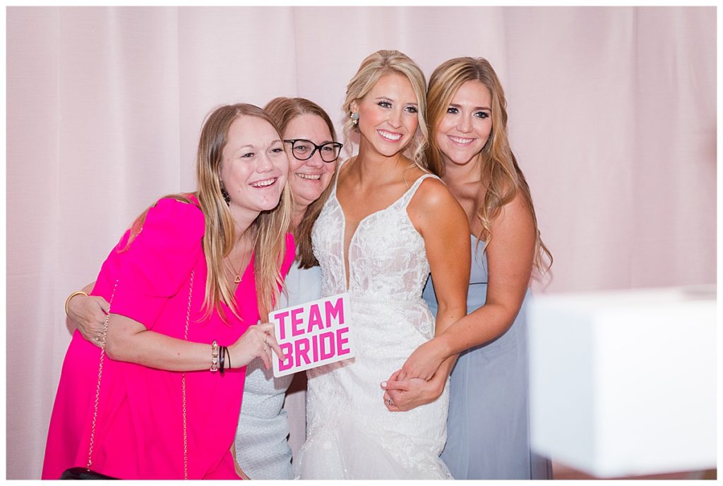 bride and friends in photobooth