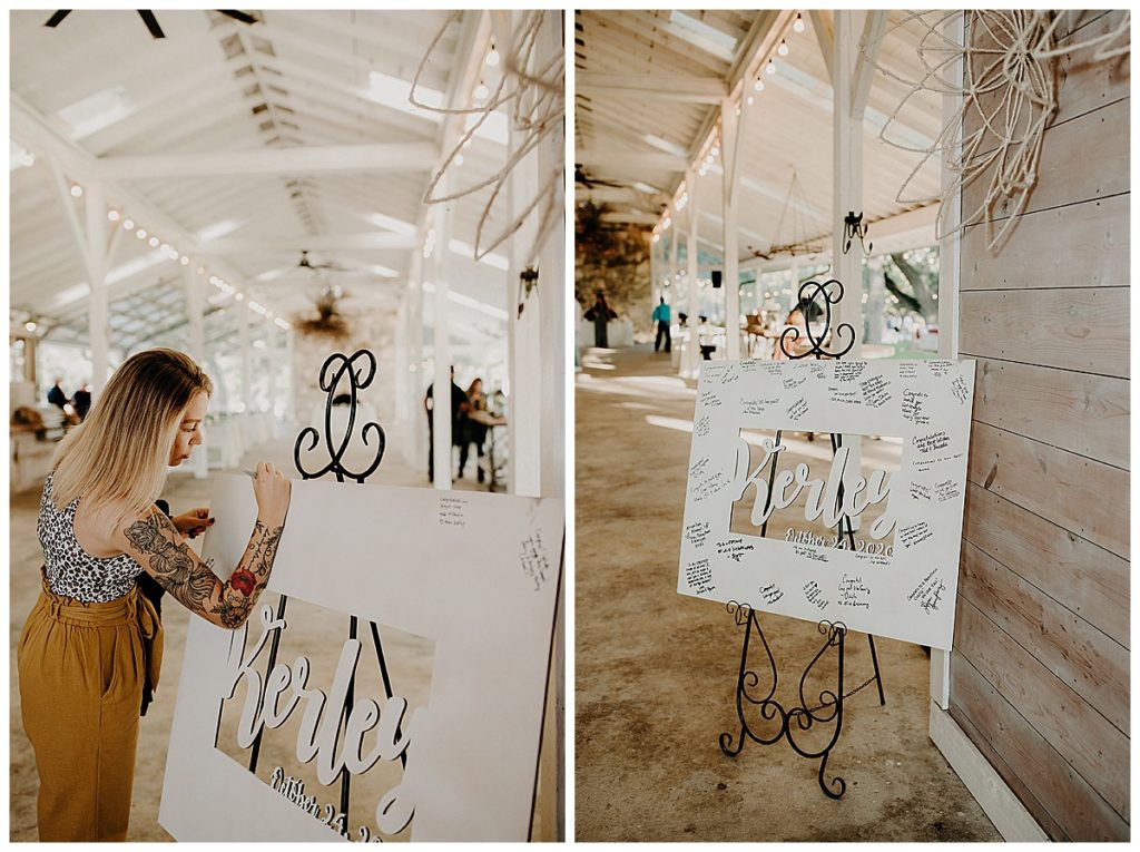 woman signing guestbook board of last name