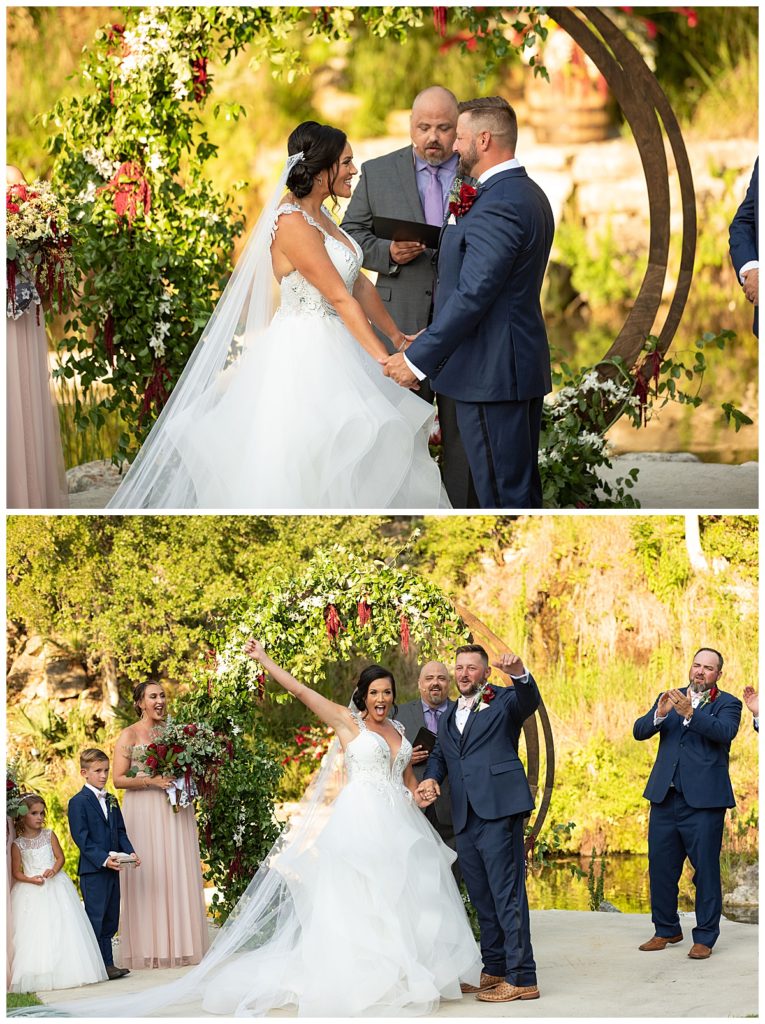 bride and groom getting married in front of circle arch with flowers