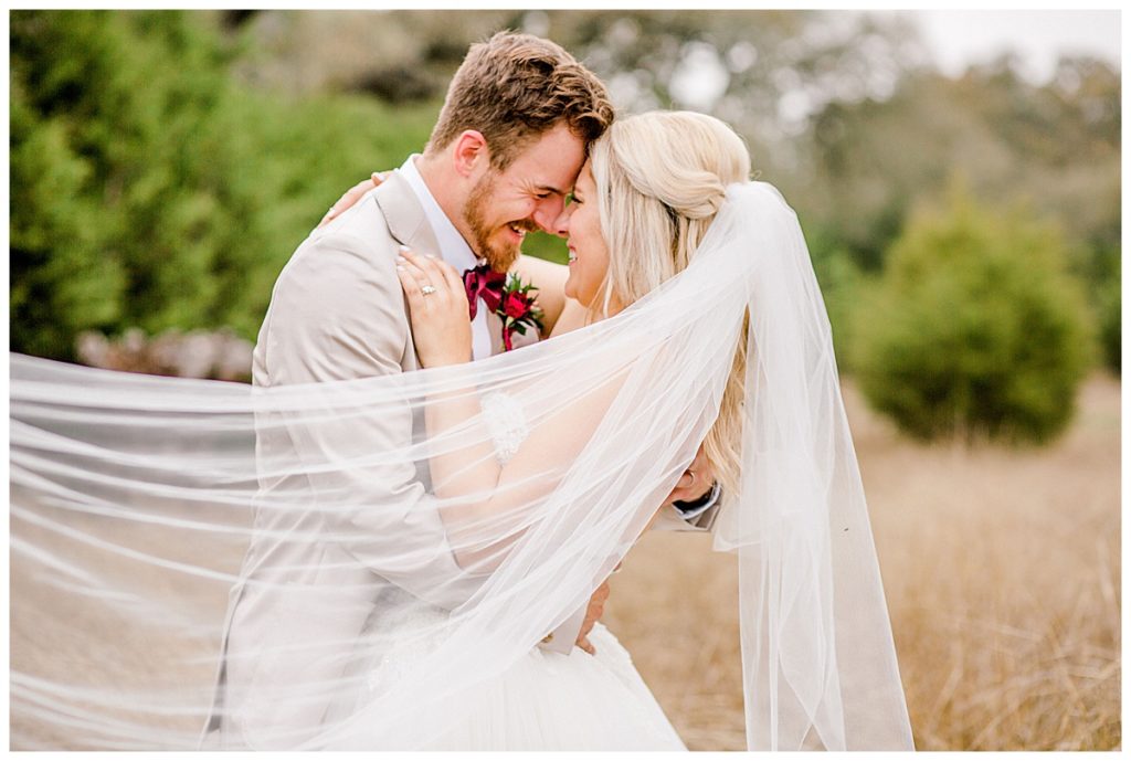 bride and groom portrait in field