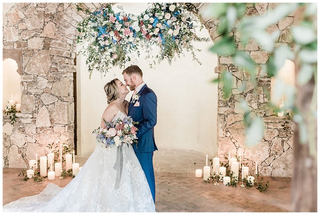 bride and groom kiss inside Ian's Chapel at Camp Lucy wedding venue