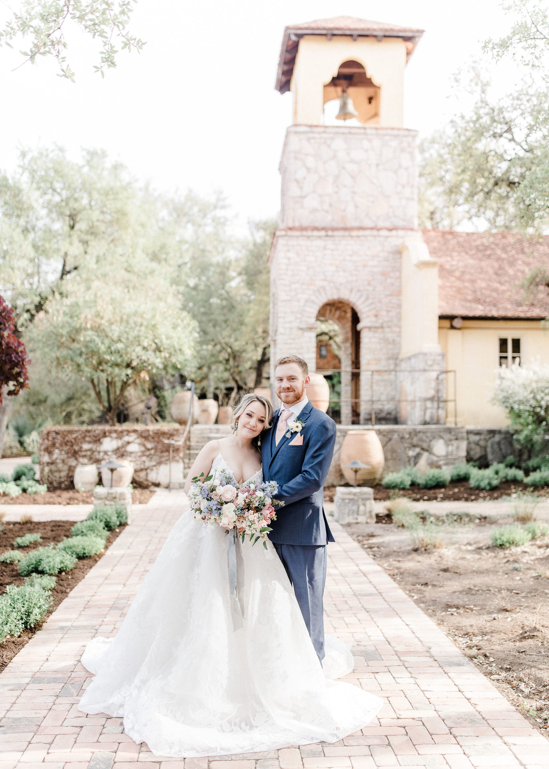 bride and groom in front of Ian's Chapel at Camp Lucy