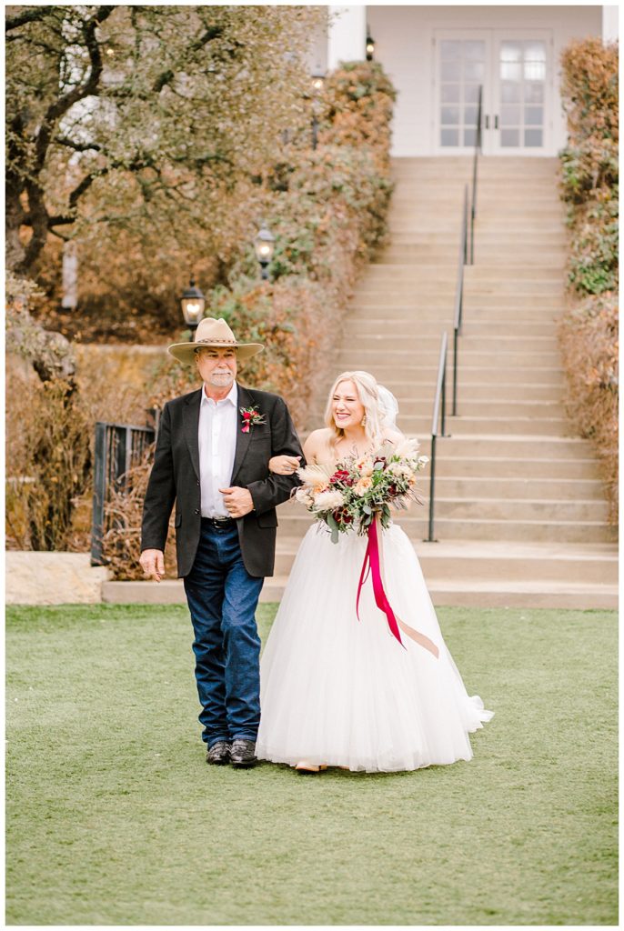 bride walking down the aisle with her dad