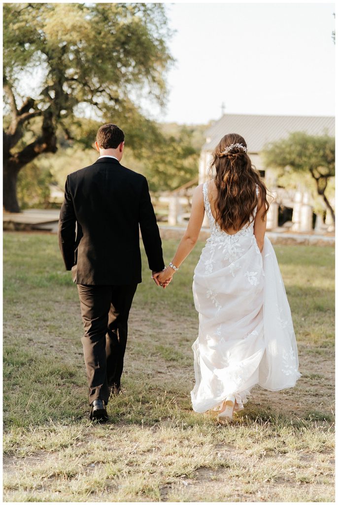 bride and groom walking away for photos