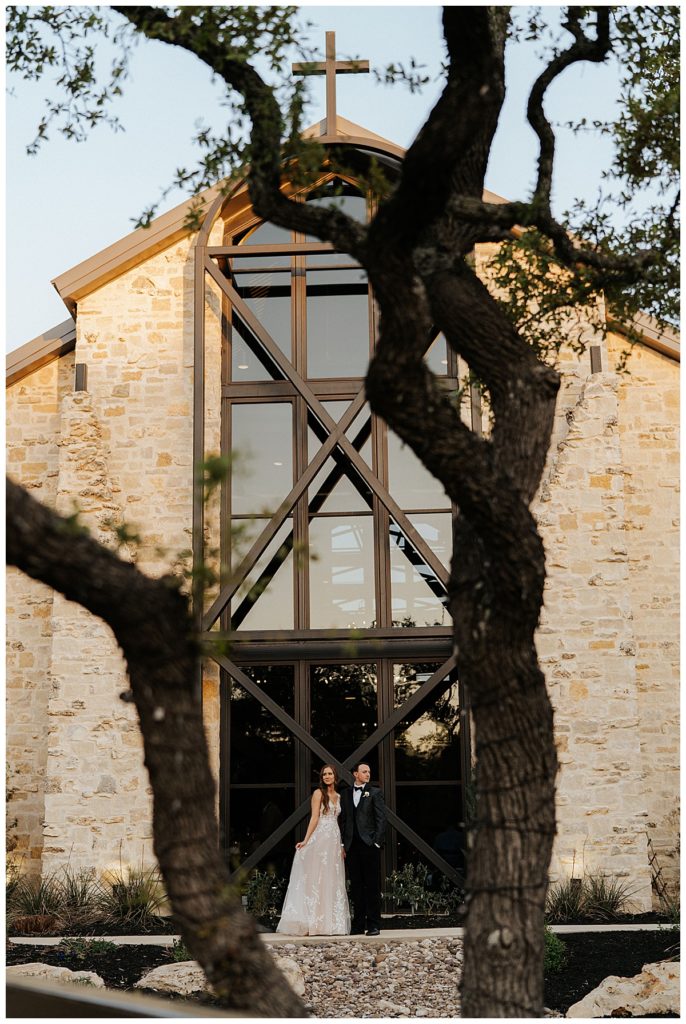 bride and groom in front of modern, industrial venue