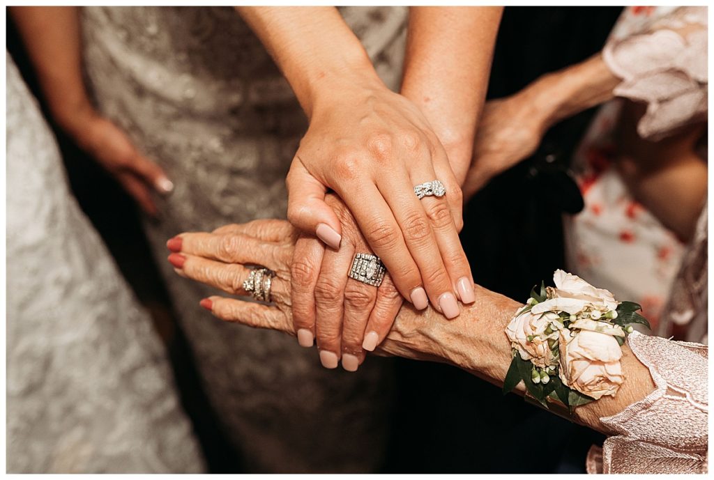 three hands with wedding bands generation photo