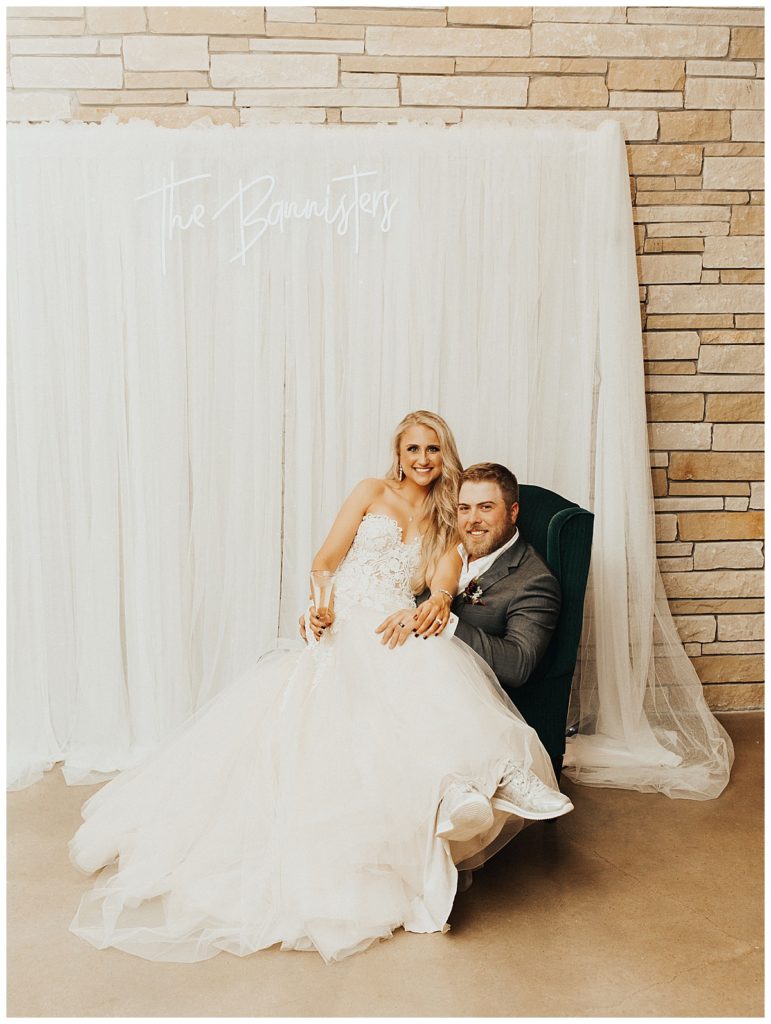 bride and groom relaxing in chair