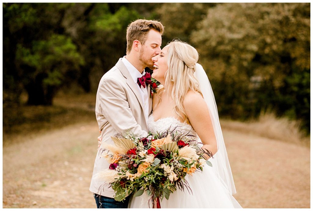 bride laughing with groom in field at Kendall Point venue