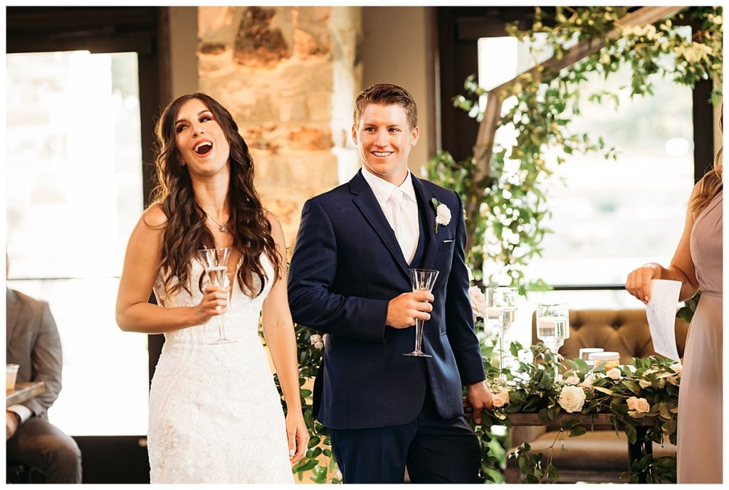 bride and groom laughing at wedding reception