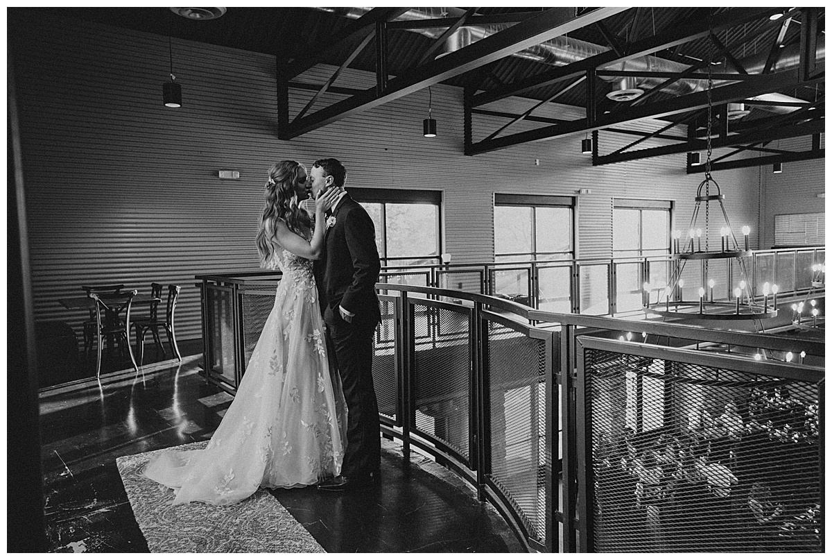 black and white photo of bride and groom kissing at Park31