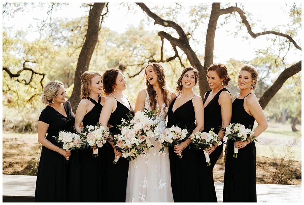 bride with bridesmaids in formal black dresses