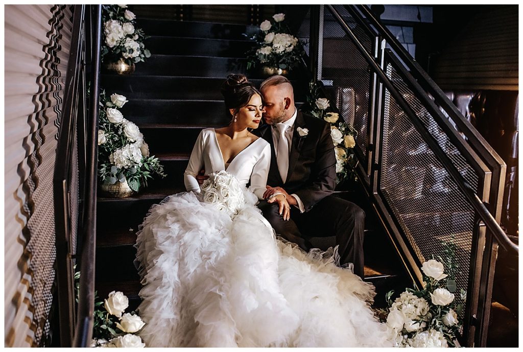 bride and groom sitting on stairs at Park31