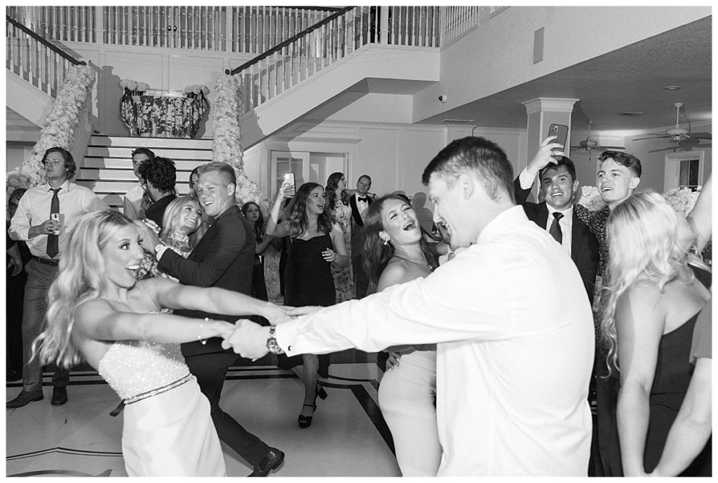 black and white image of bride and groom dancing during reception