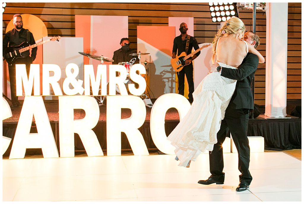 bride and groom dance in front of band