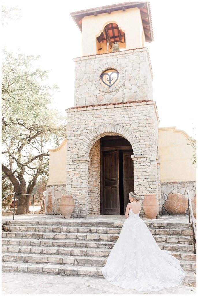 bride standing in front of Ian's Chapel at Camp Lucy