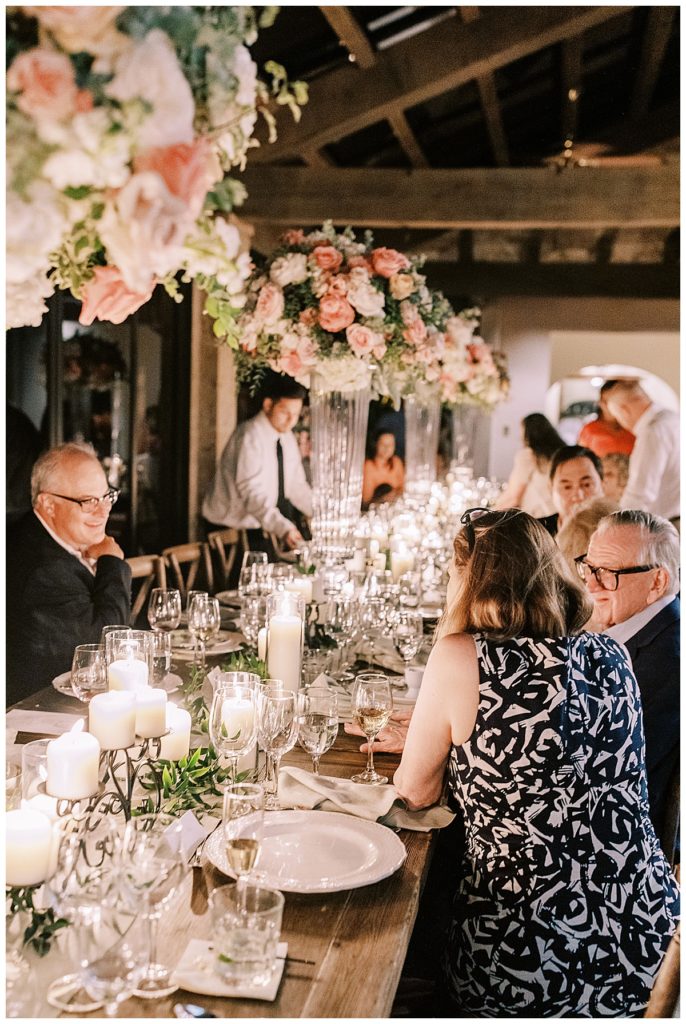 family gathered around a candlelit table at dinner