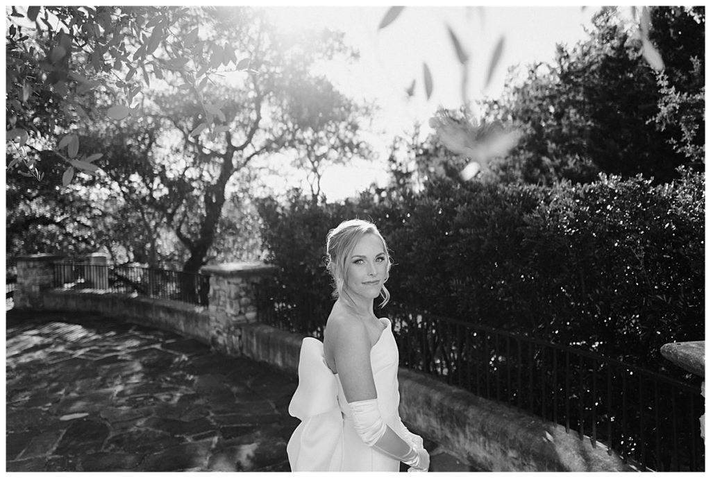 bride poses in timeless wedding dress with bow