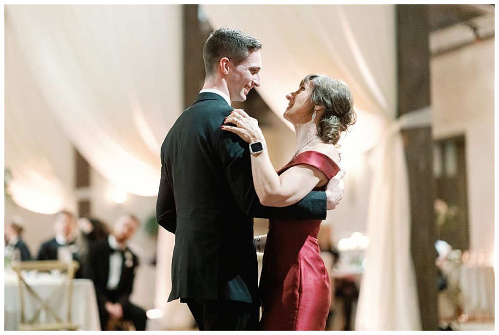 groom dances with mom at reception