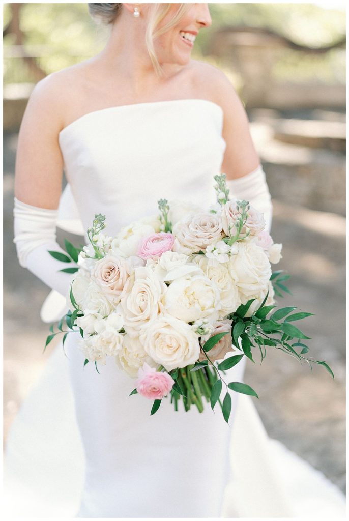 bride holding all white bouquet