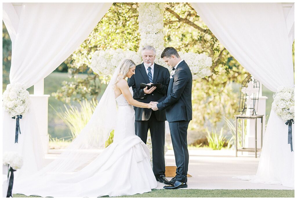 couple pray together during Kendall Point wedding ceremony